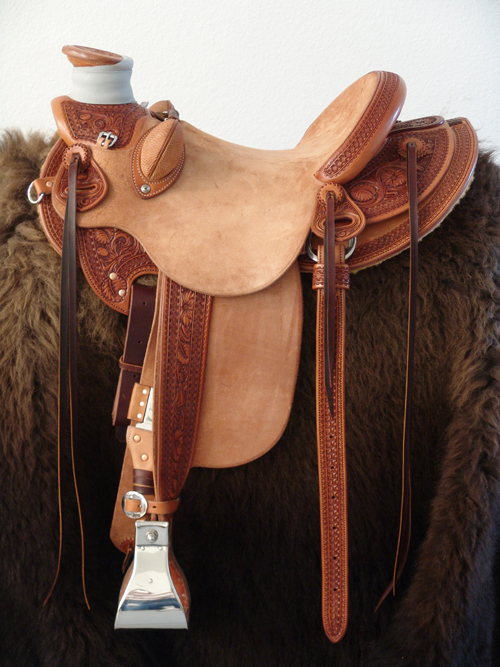 8 & 1/2 Half Breed Wade Saddle by Keith Valley   Specs: Wade tree by Rick Reed 16 inch seat Gullet - 7 & 1/2H by 6 & 1/4W by 4 93 Degree Bars Horn - 3 & 5/8ths high by 4 & 1/2 Guatelajara Cantle - 4&1/2 inches high by 12&1/2 inches wide Cheyenne Roll - 1 & 3/4 inches 7/8ths flat plate riggin Geometric Border with Sheridan Style Floral Stainless Steel Hardware - by Harwood 4&1/2 inch Monel Stirrups Santa Barbara twisted stirrup leathers Full length stirrup leathers 32 inch 100% Mohair Roper Cinch 7 foot latigos - both sides Ready to ride and go to work.